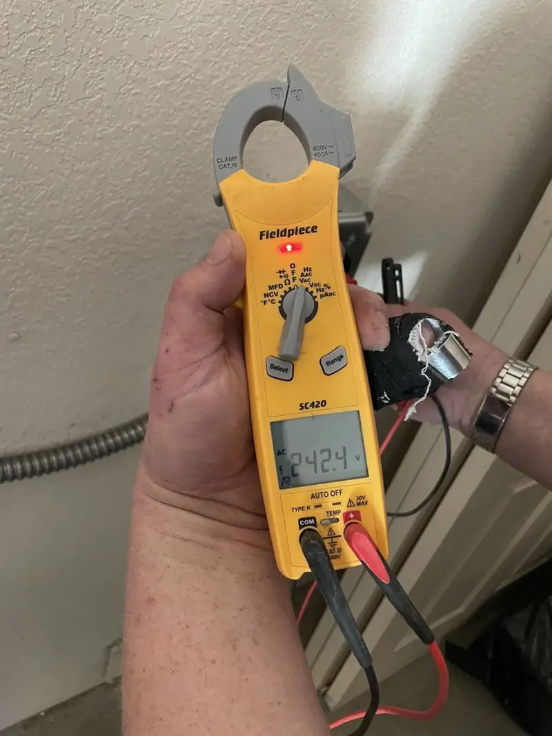 Voltage testing with clamp meter during Ceiling Fan Installation in DeCordova